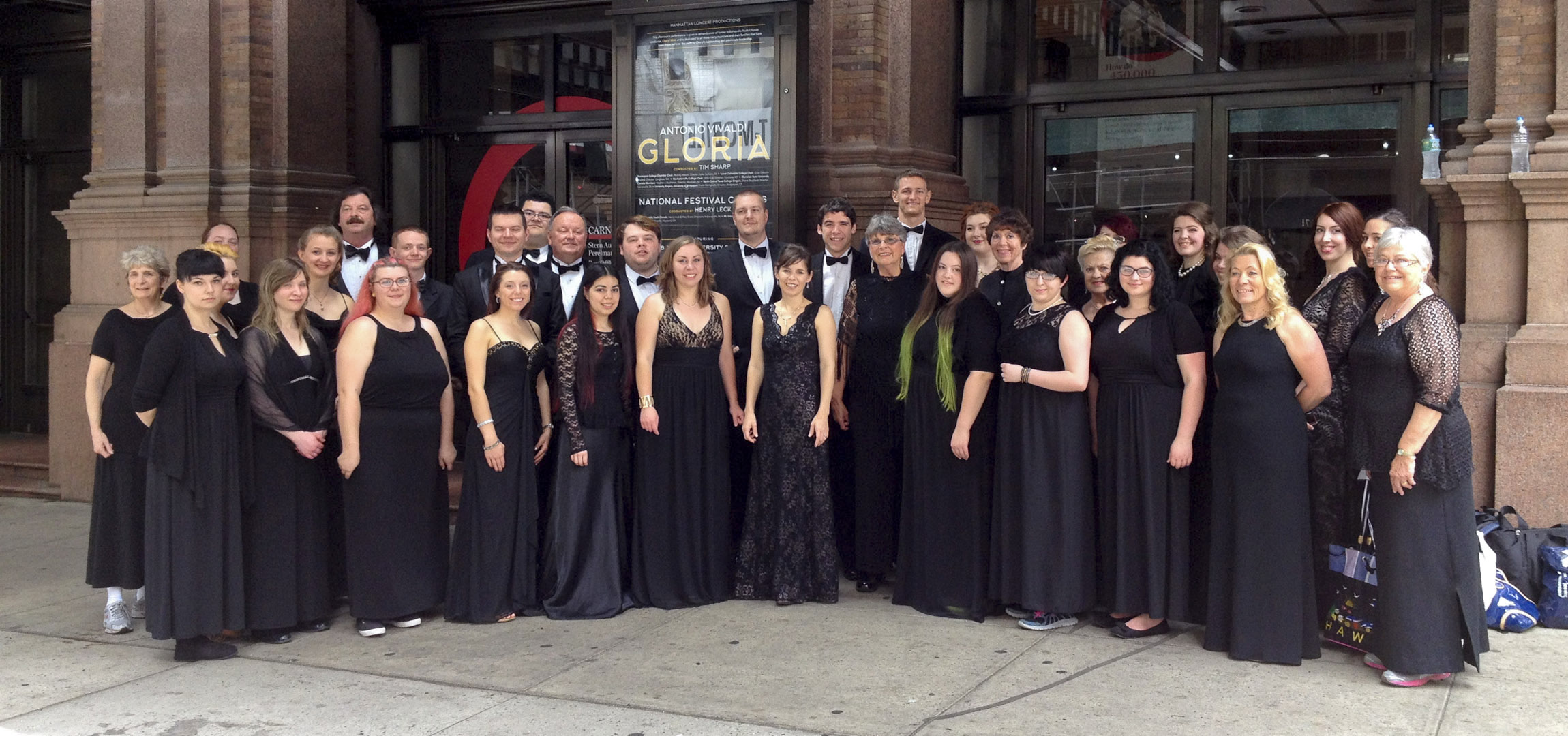 LCC Choir in black suites and dresses in front of carnegie hall