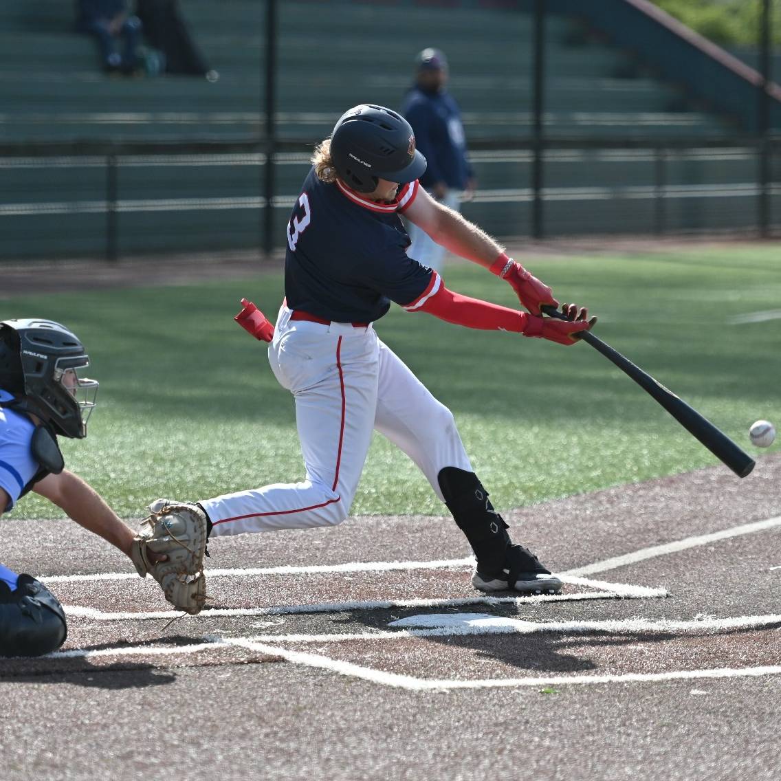 A baseball player swinging a bat on a field.