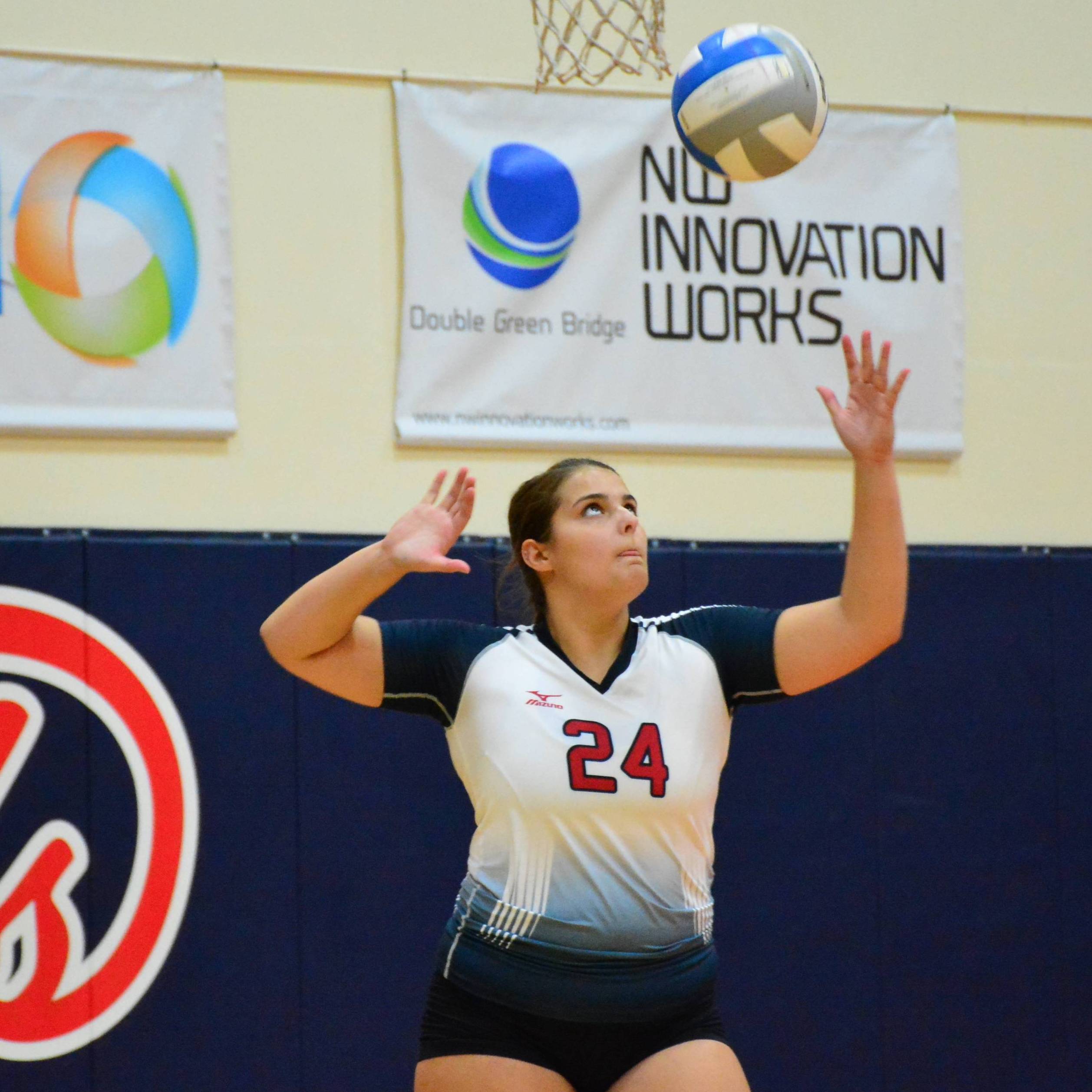 An LCC Volleyball player about to spike the ball.