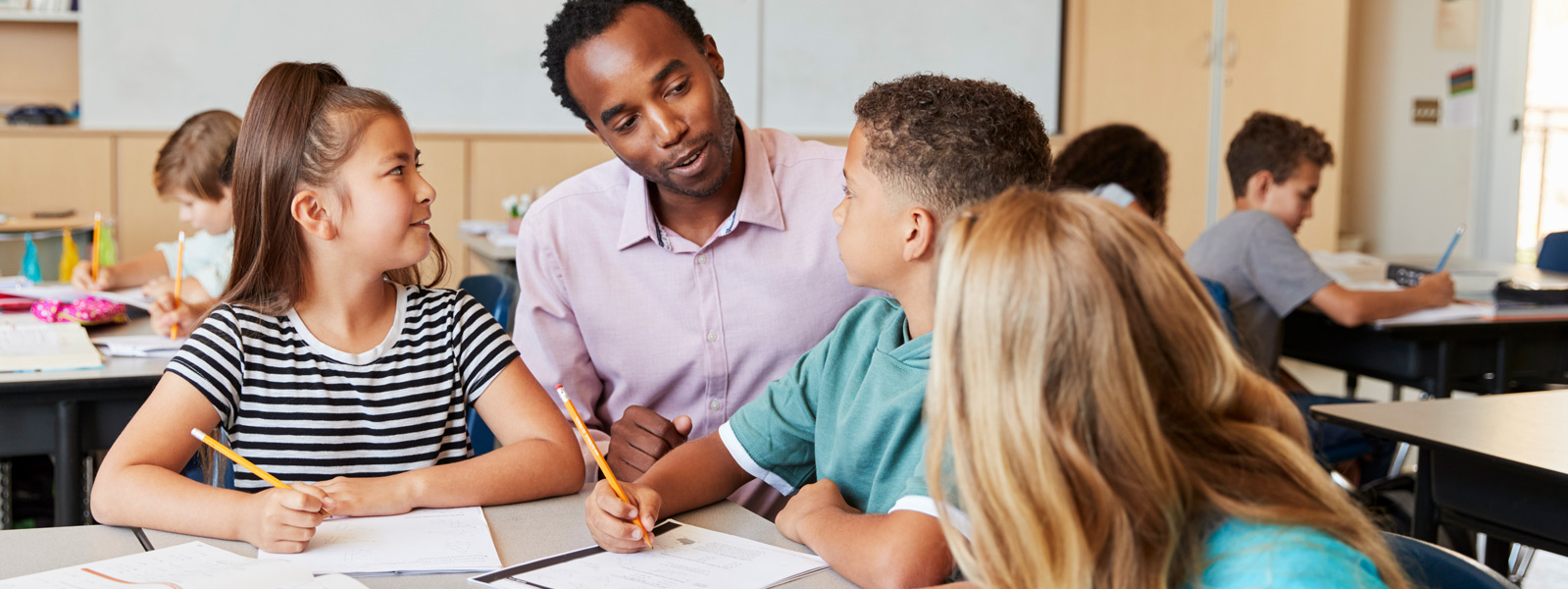 Teacher working with 3 young students