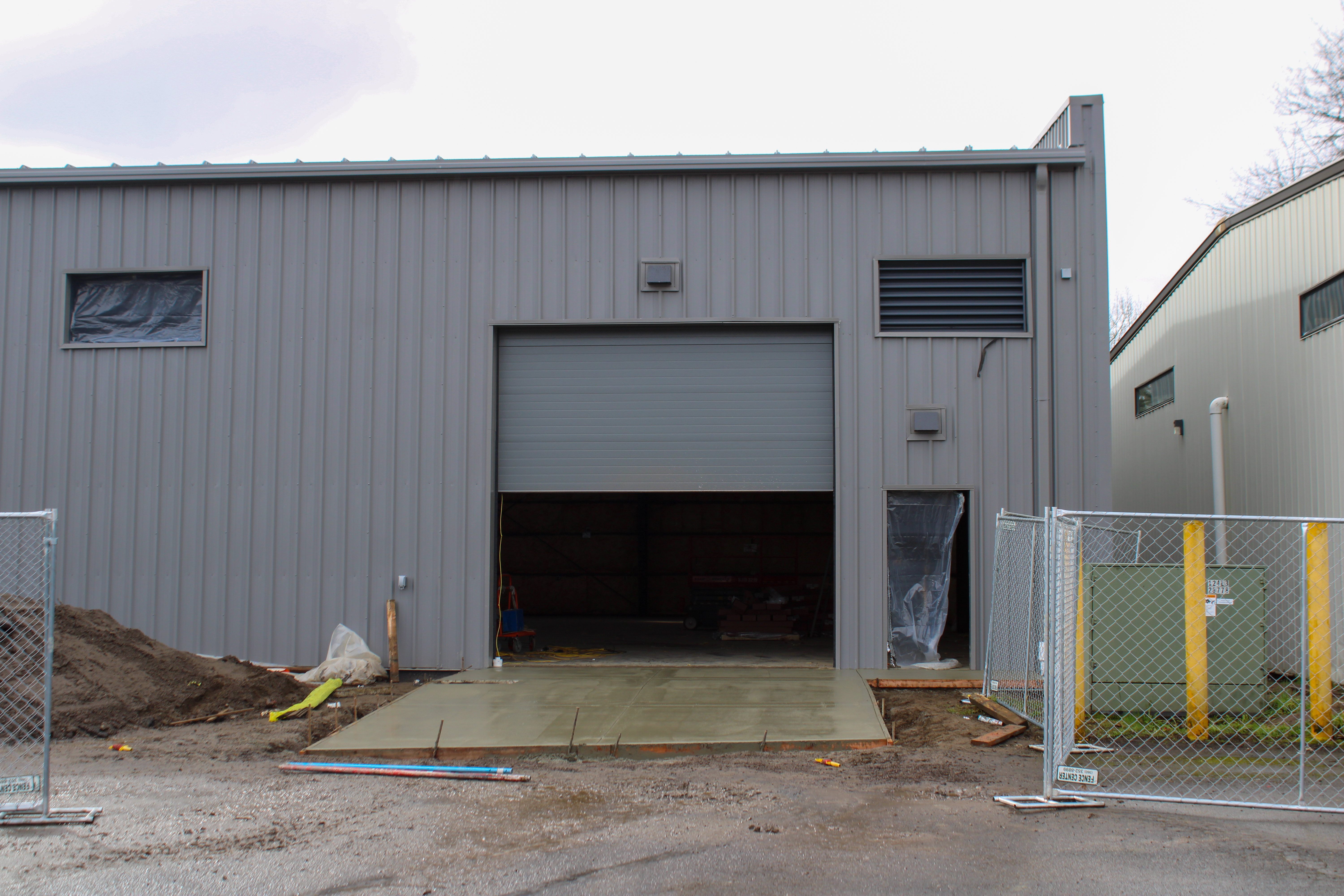 front entrance of indoor sports facility woth large truck doors.