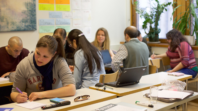 high school strudents studying at desks in a classroom