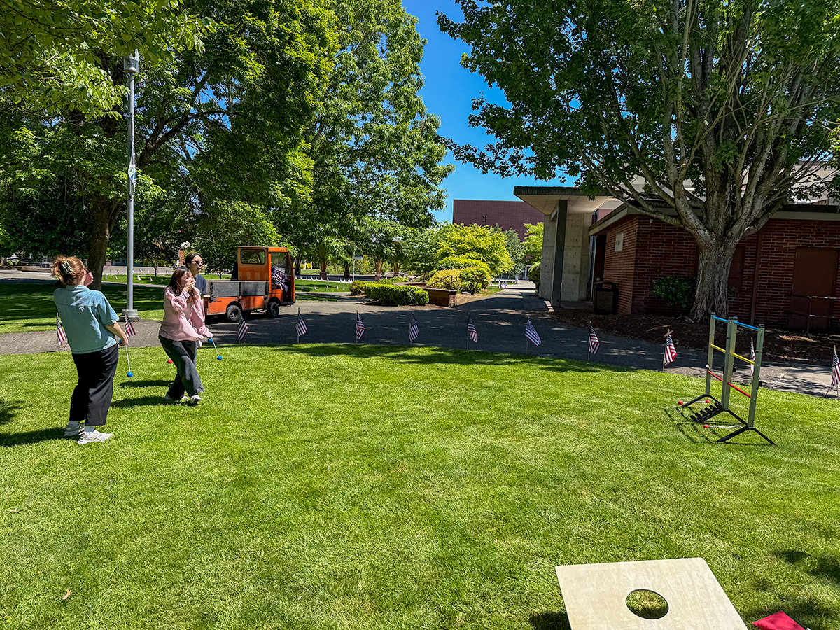 Ladder toss students playing ladder toss in the grass