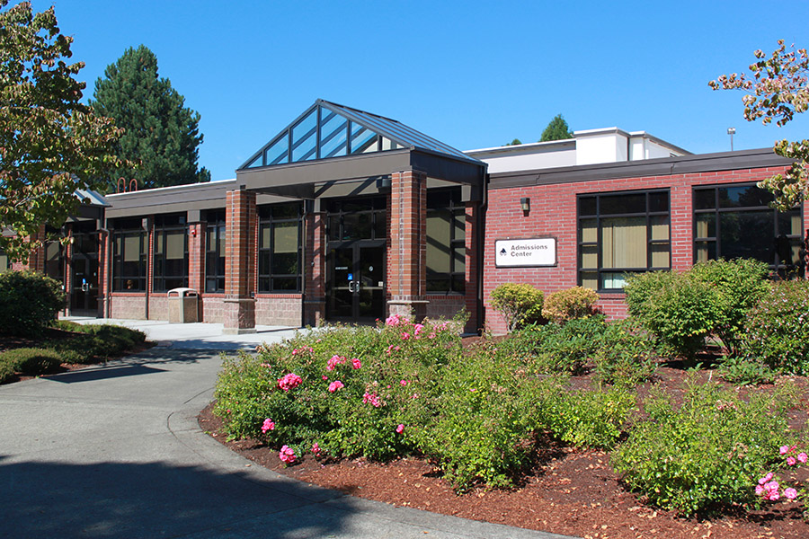 LCC admission building entrance with spring flowers in bloom