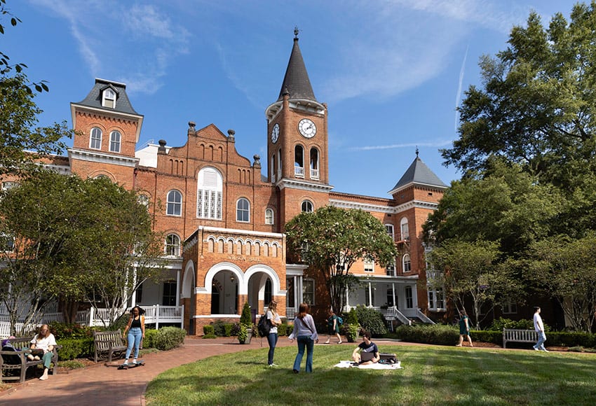 Converse University building with students in the quad and blue skies
