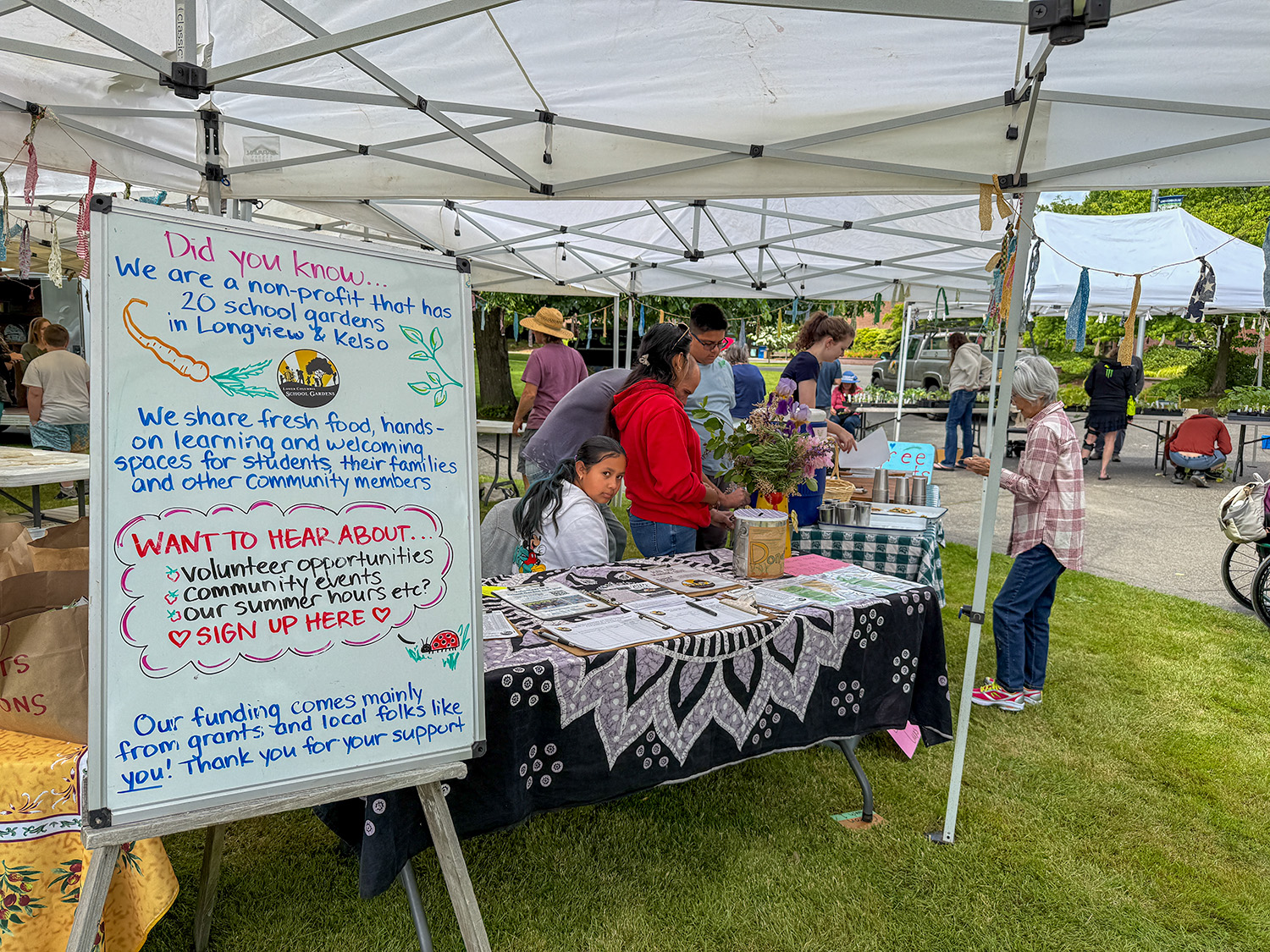  an outdoor informational booth set up by Lower Columbia School Gardens