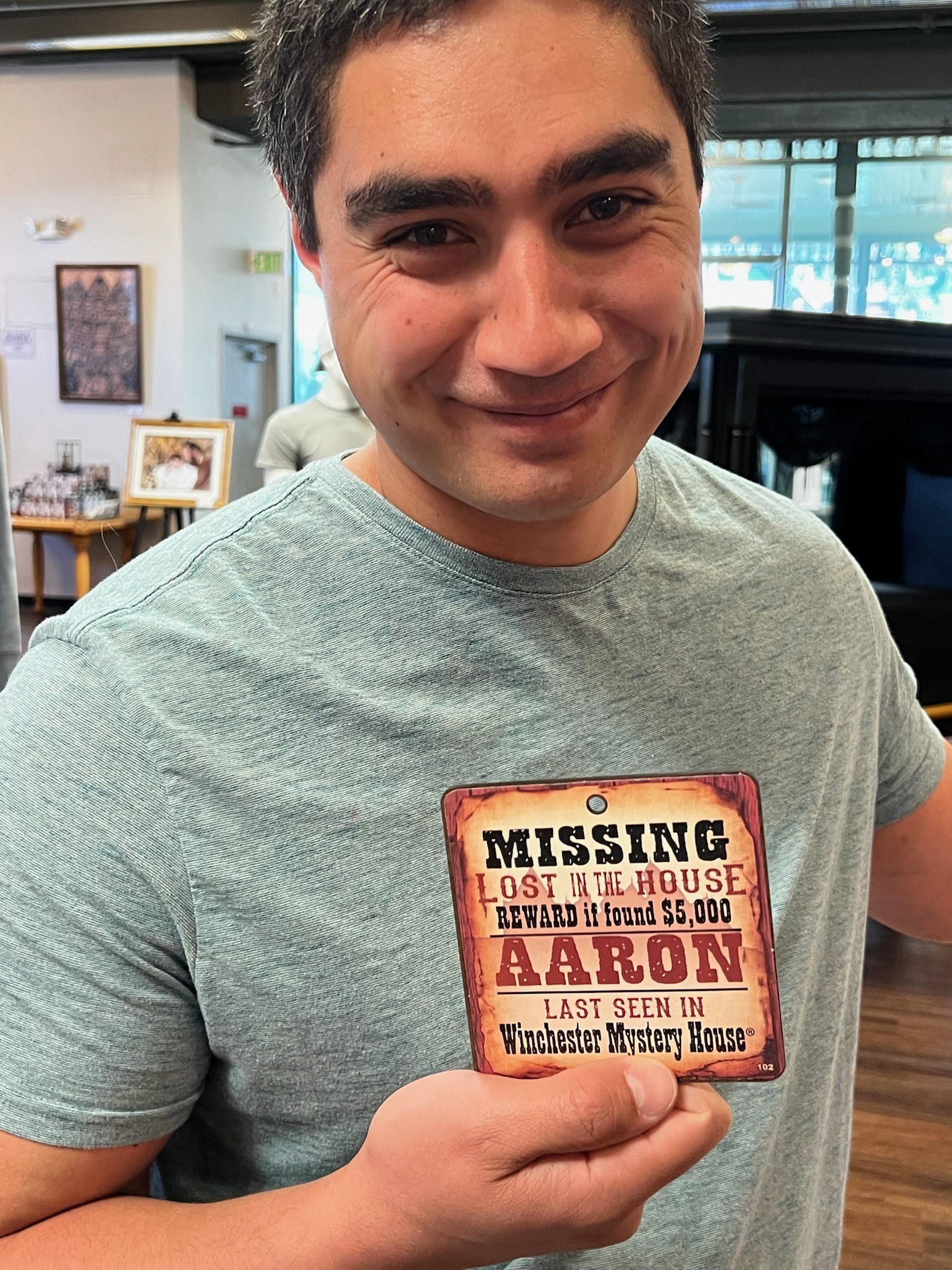 Aaron holding a souvenir from the Winchester Mystery House.