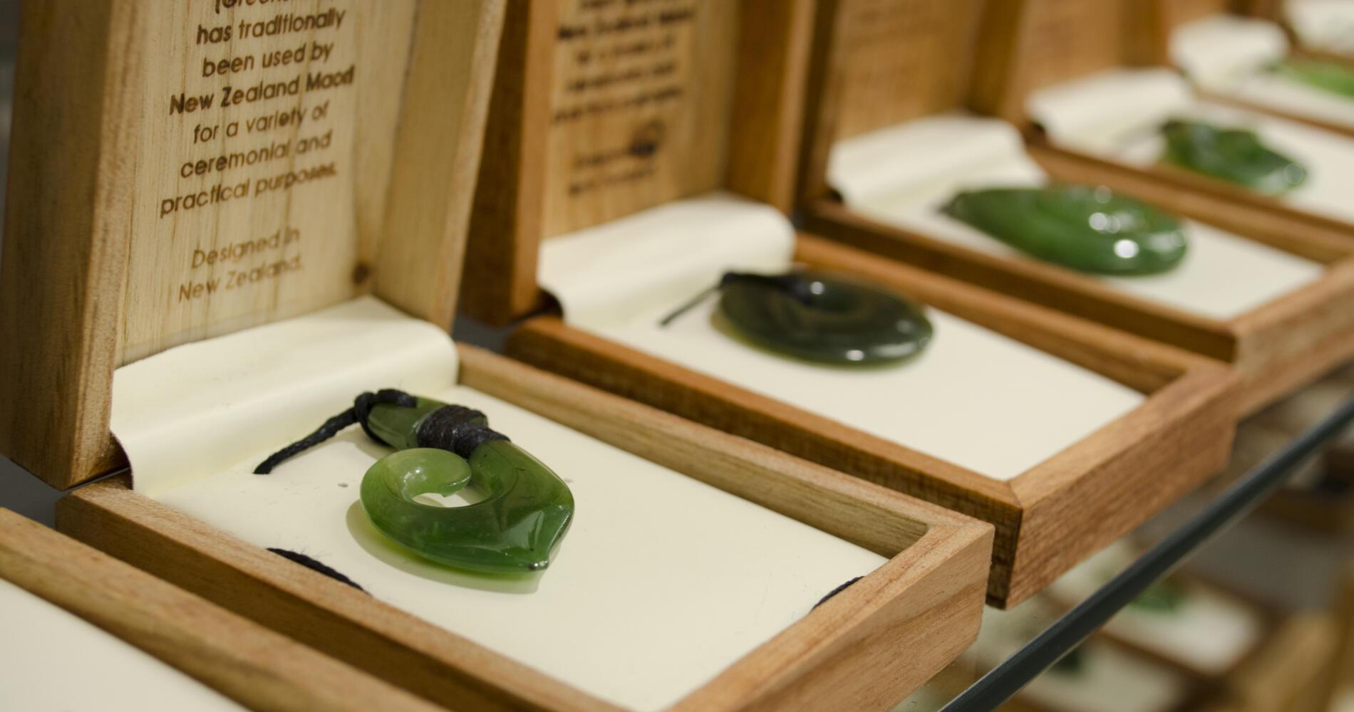 A row of necklaces featuring a green stone.