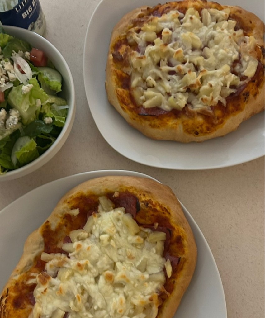 Breaded pasta bowls and salad on a kitchen table