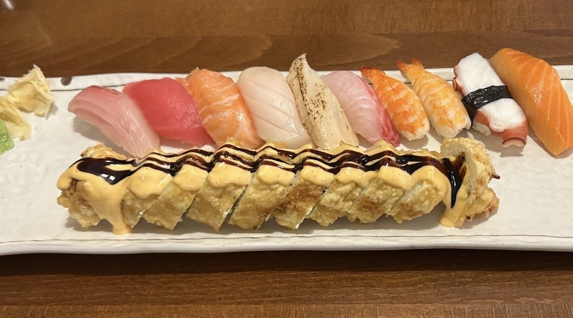 sushi rolls displayed on a white plate on the table.
