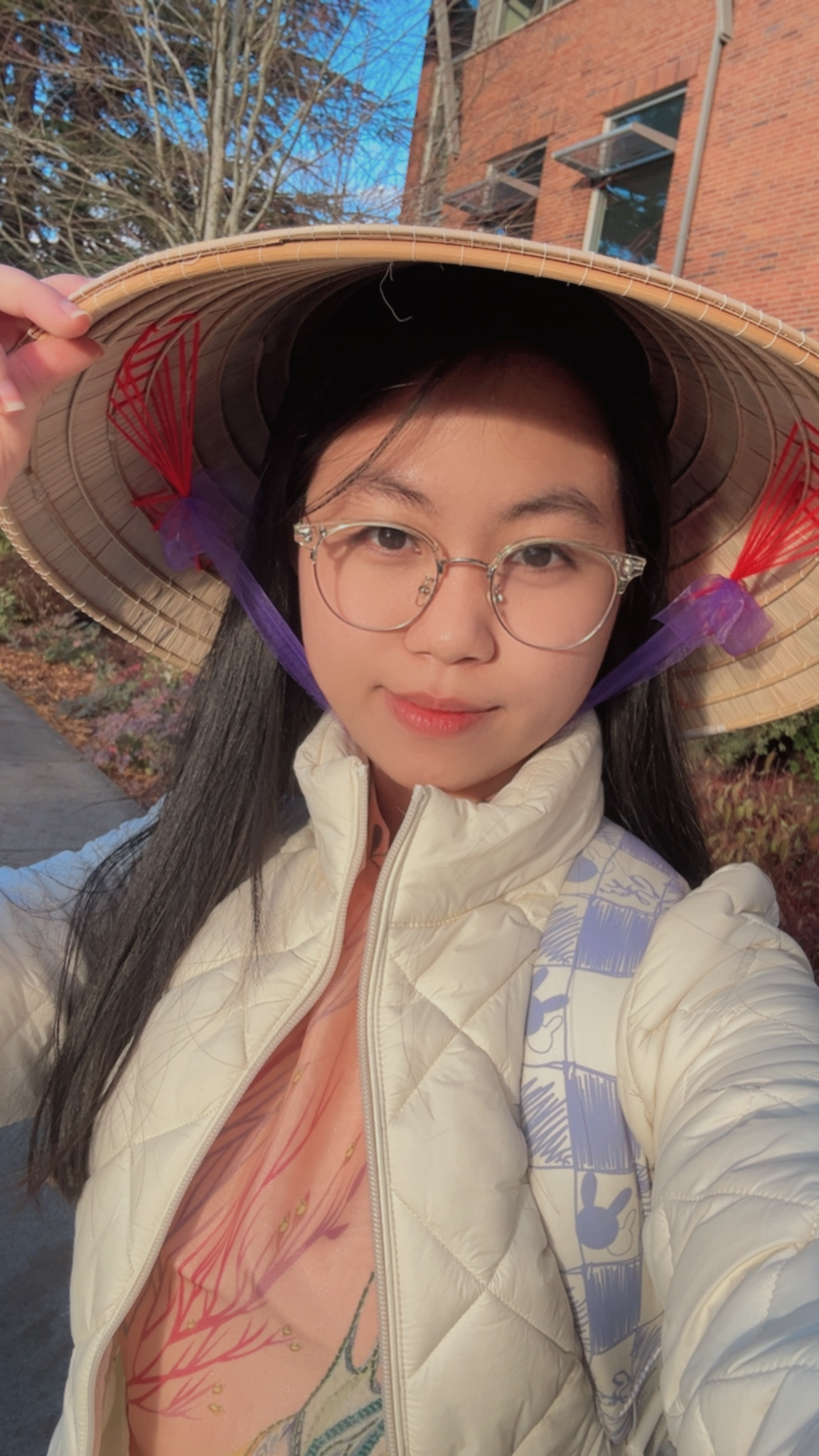 International Student Thuan wearing a traditional hat and taking a selfy