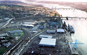 ariel view of industrial Vancouver Washington, show two bridges and ships at the port docks.