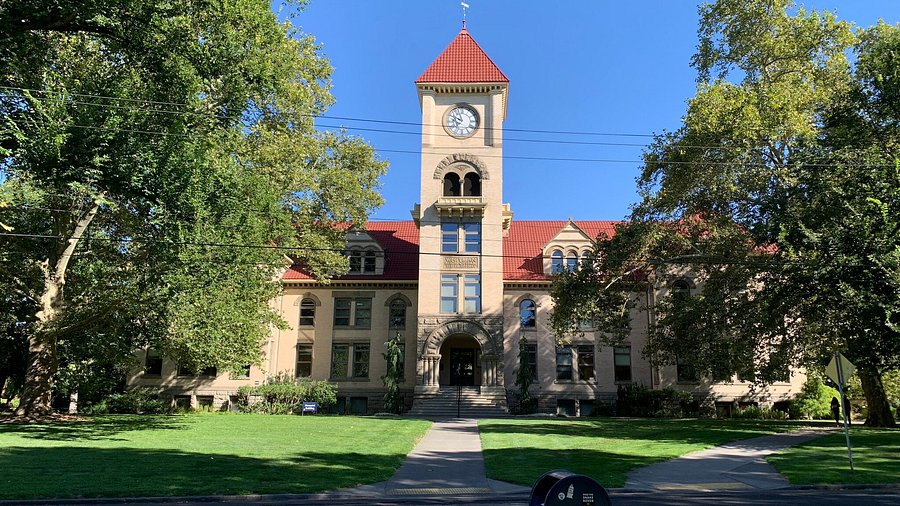 Whitman College building surrounded by green trees and blue skies