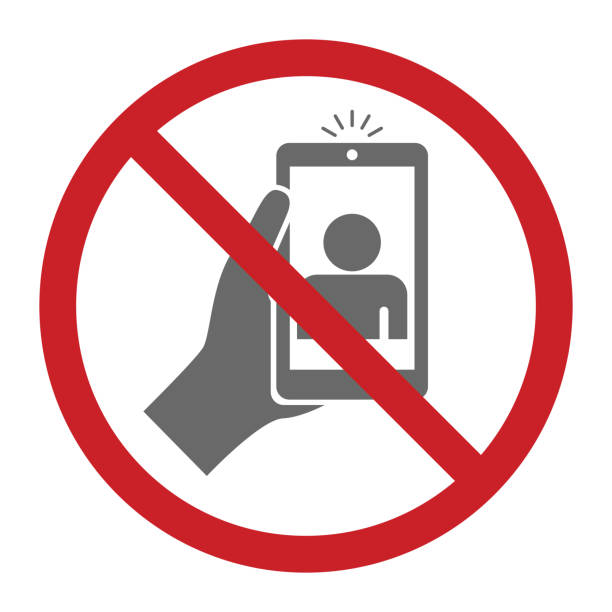 Do not disturb sign of someone holding a cellphone with a red circle and cross