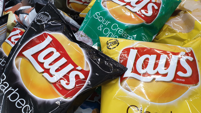 black, yellow, and green bags of lays chips