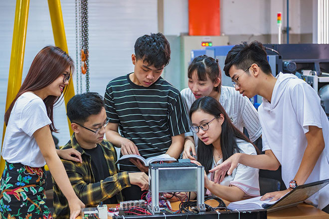 International Students working in a manufacting lab on a college campus