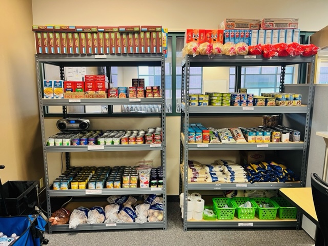 Food pantry shelves filled with multiple shelves of non perishable items