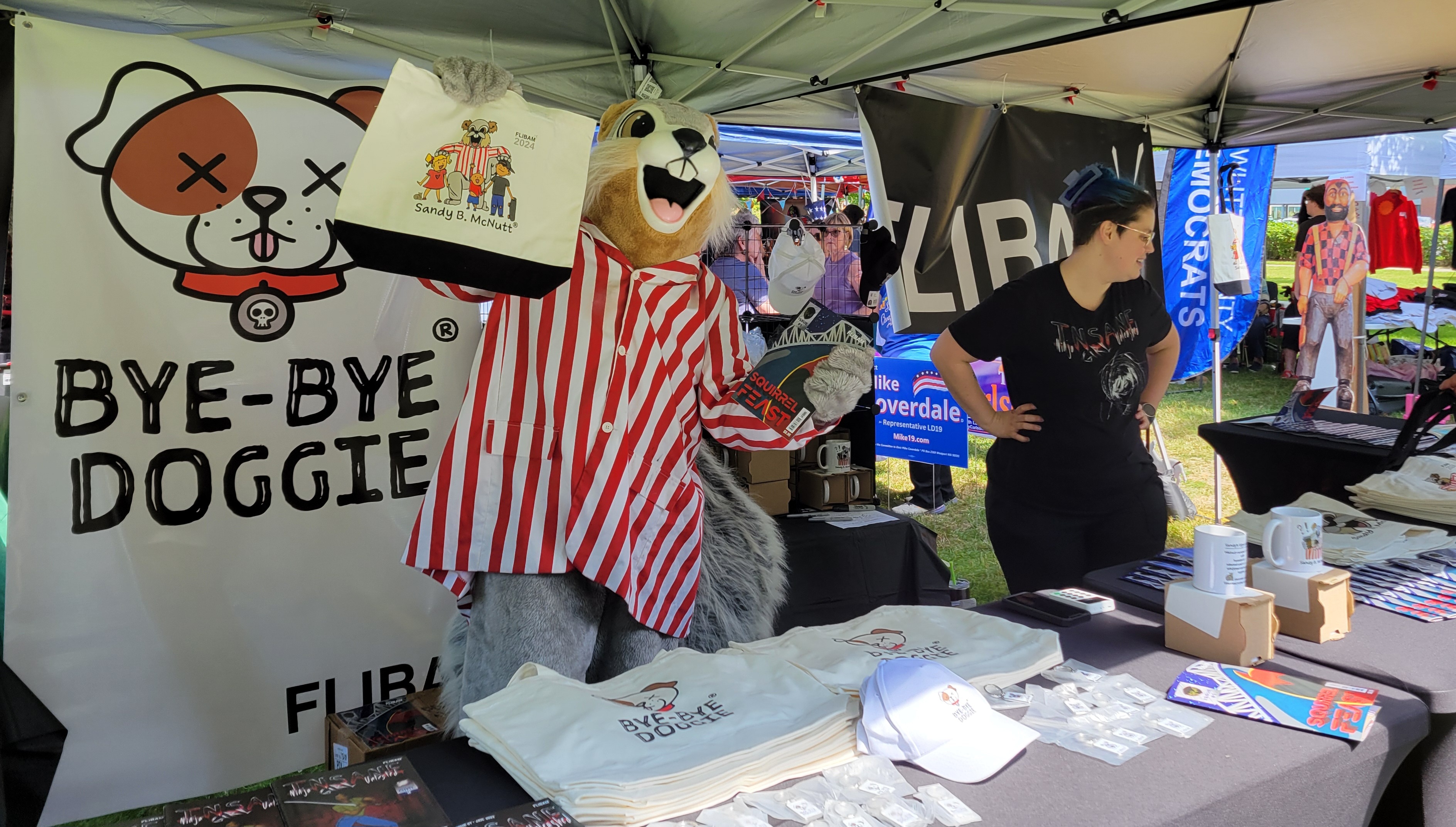 Squirrel fest squirrel holding a bag of goods at the Bye-bye doggie booth