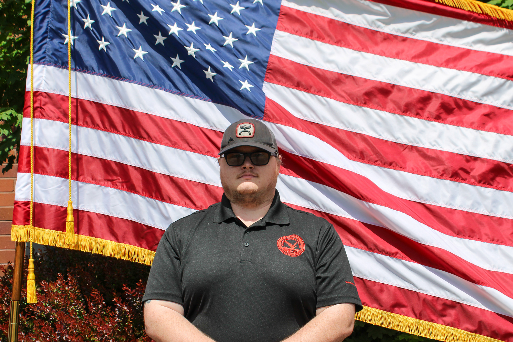2025-2026 President of the Veterans Alliance Club 2025-2026 President of the Veterans Alliance Club standing in front of the American flag
